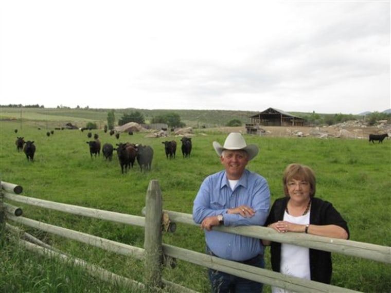 Craig and Mary K. Vejraska pose at their cattle ranch June 17, 2011, in Omak, Wash. They support the use of cattle brands in a new animal identification program.